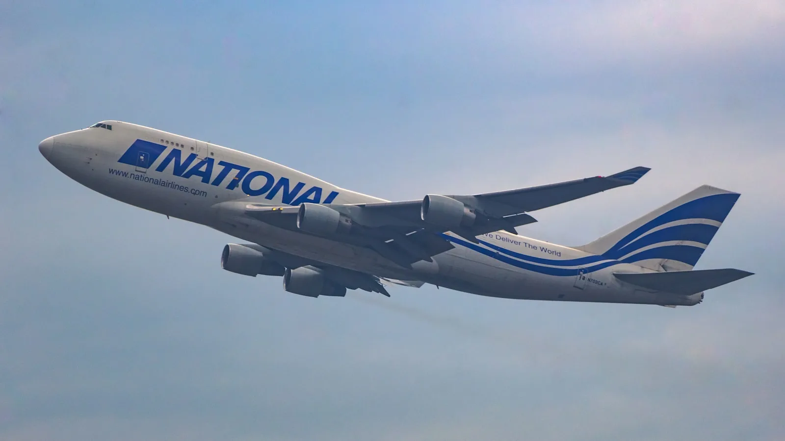 a large jetliner flying through a blue sky